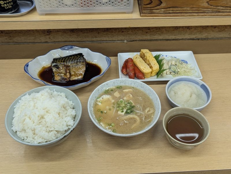 さばの煮付けにご飯、汁物、小鉢を並べた定食